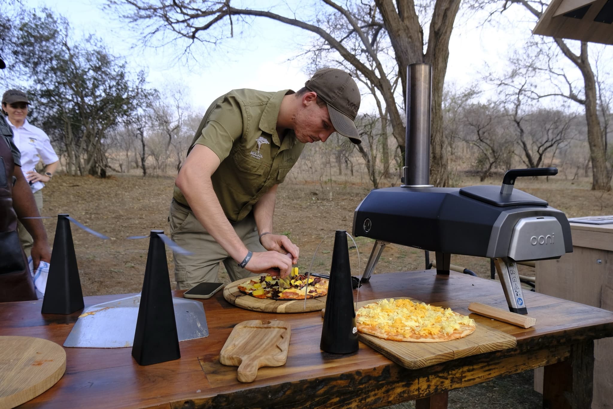 Guide making pizza at the outdoor Ooni oven