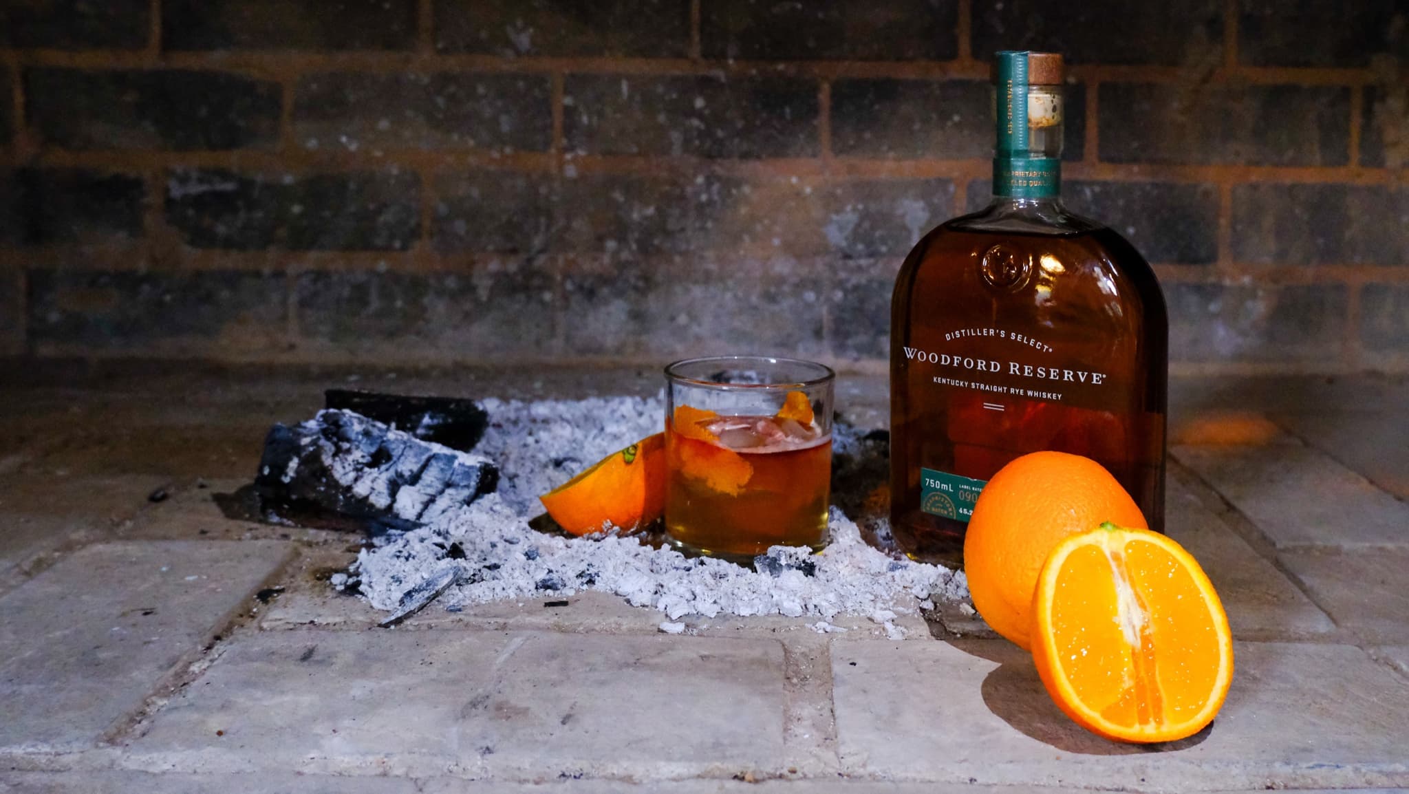 Woodford Reserve old fashioned cocktail with orange by the hearth
