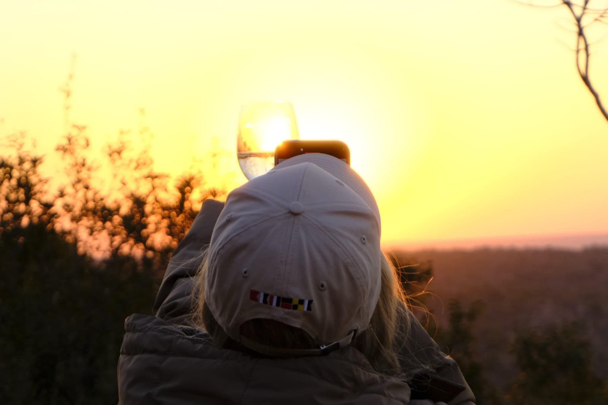 Guest watching sunset with glass of wine