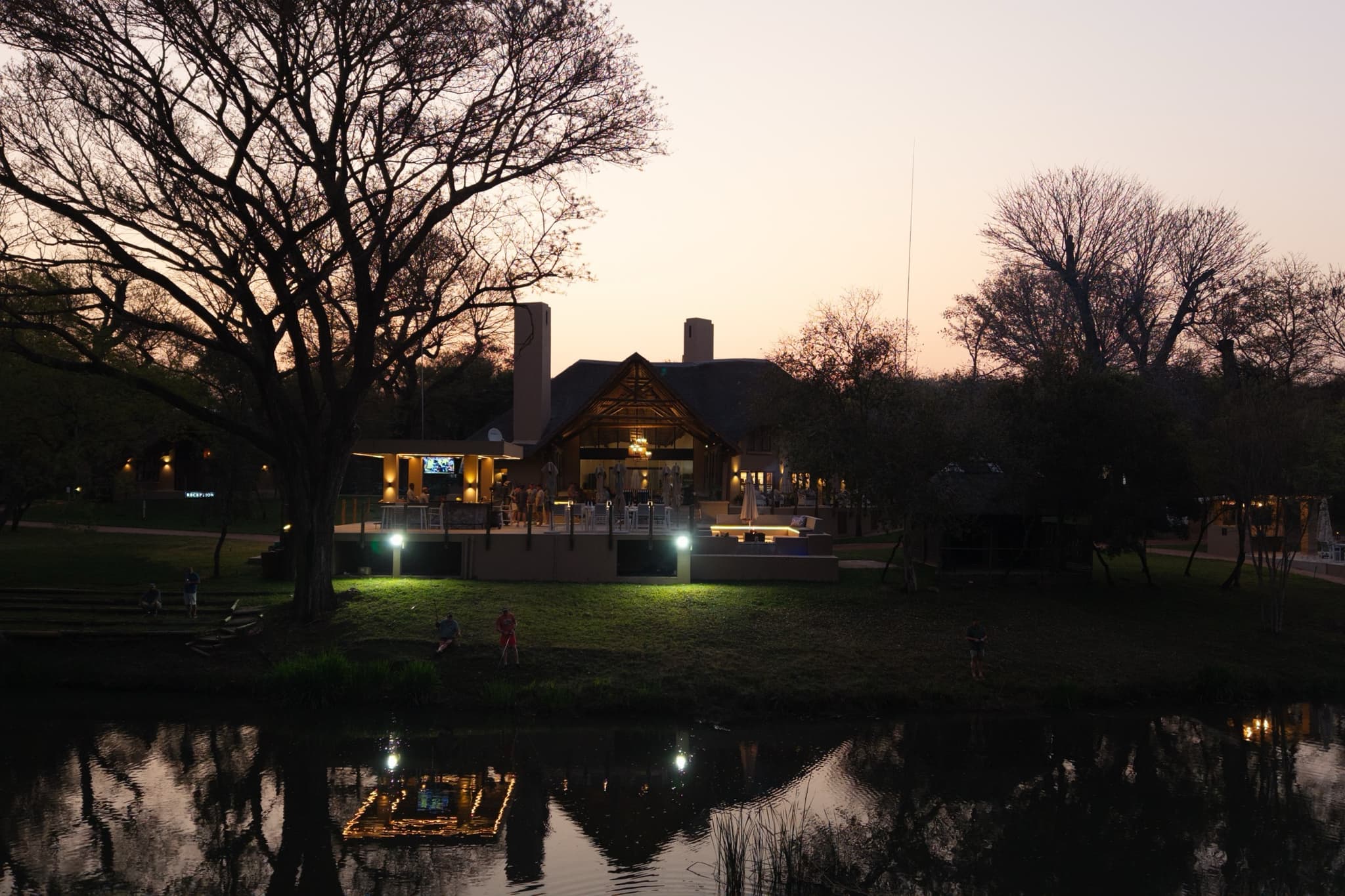 Lodge at dusk reflected in the river