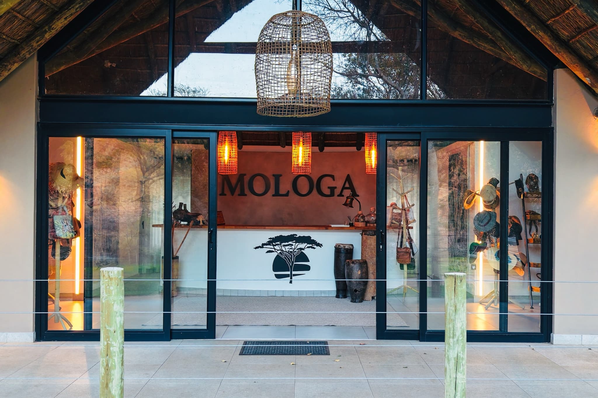 Lodge entrance with glass doors and thatched roof