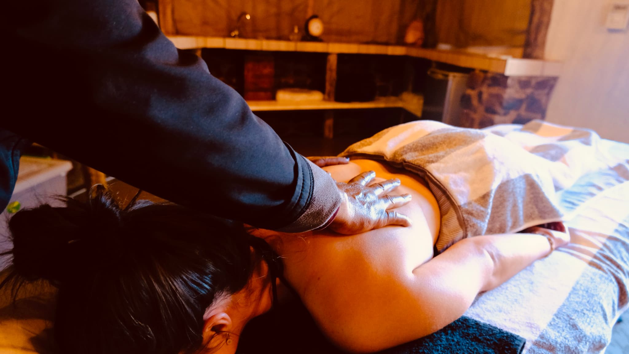 Back massage treatment in the stone-walled spa room